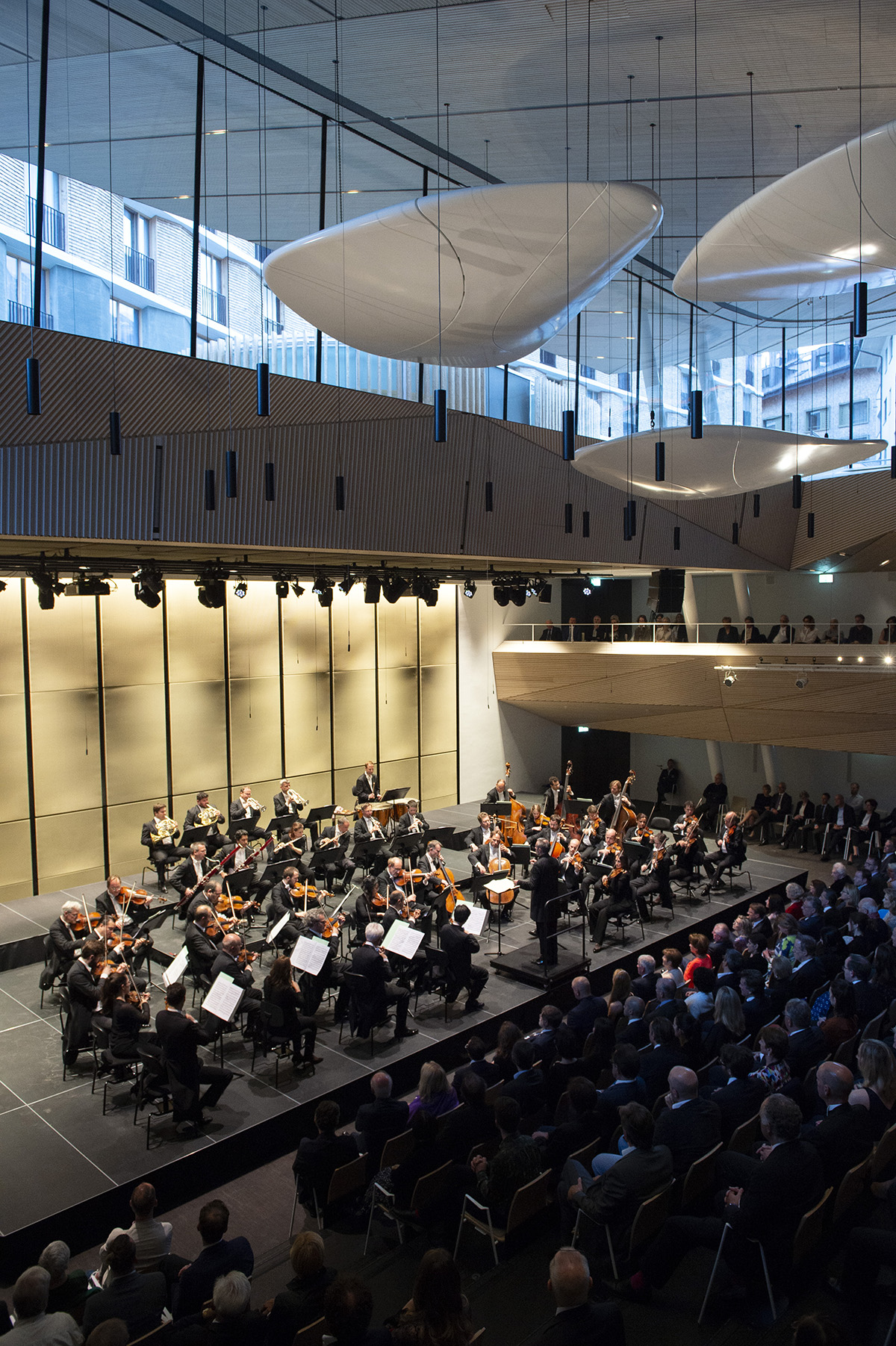 Orchestra playing in contemporary concert hall