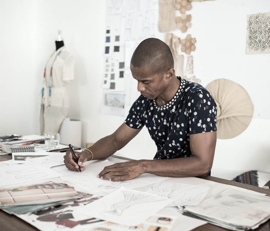 Fashion designer at work drawing in the studio