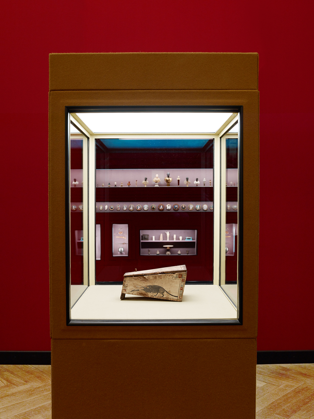 Very small coffin shown inside a glass cabinet at a museum