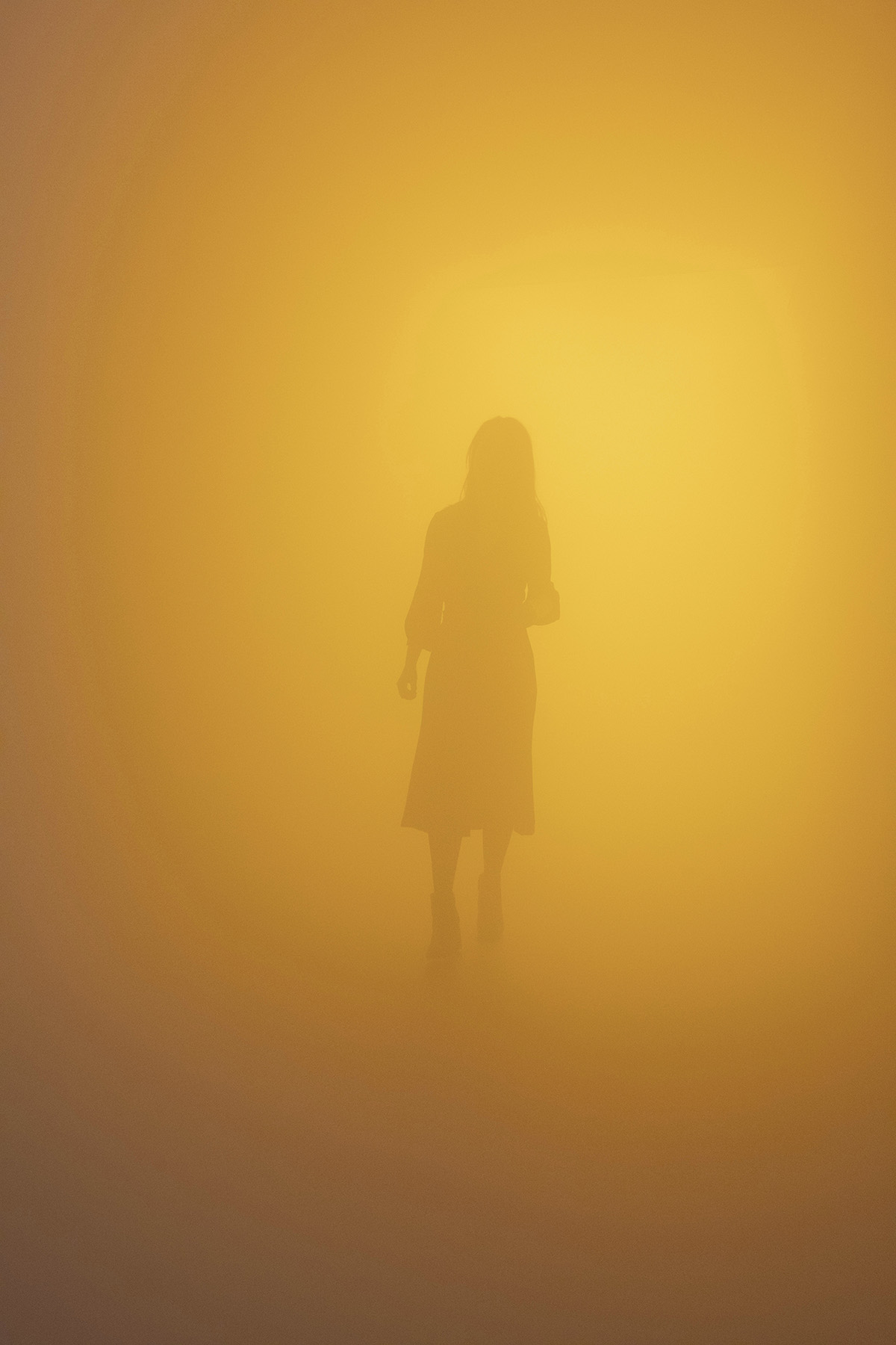 Figure emerging from yellow mist
