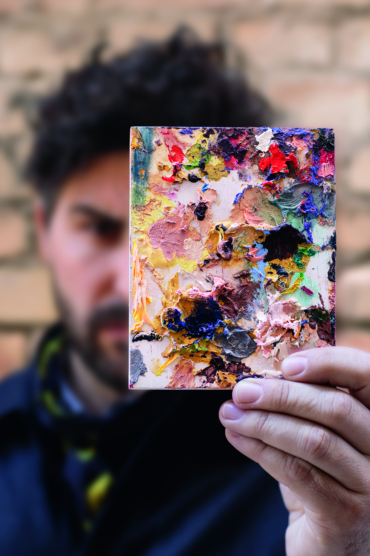 A man holding a paint palette