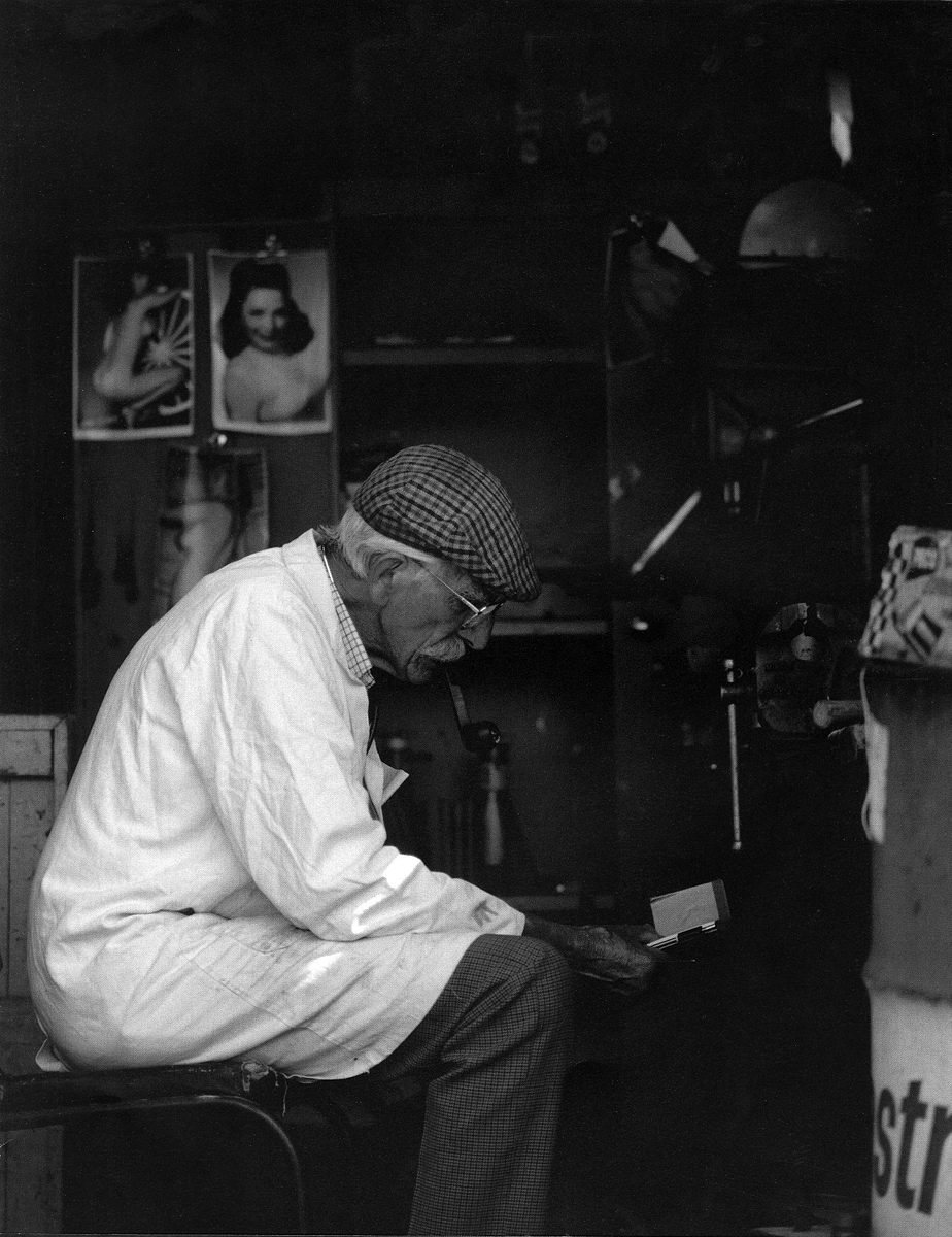 Engineer sitting in his workshop in a white coat