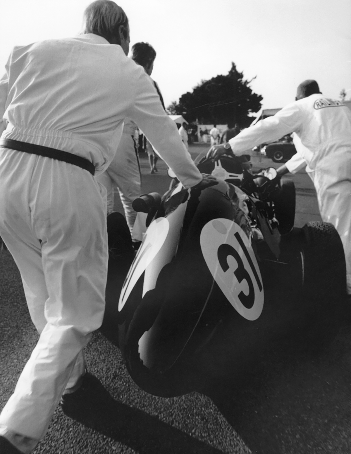 Racing team push off vintage racing car