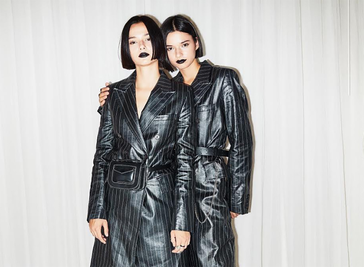 Twin models in black coats
