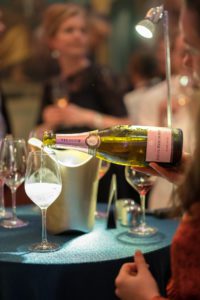 Bottle of champagne being poured into a glass