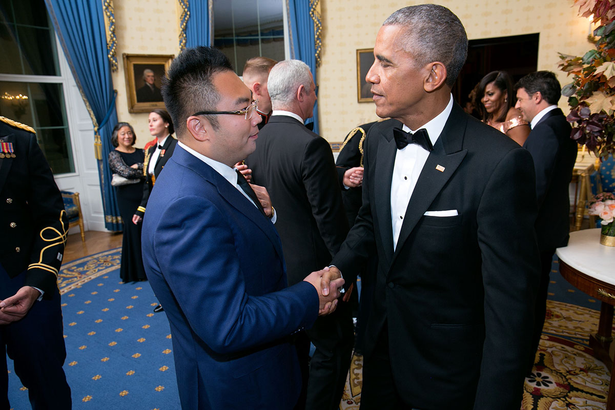 Barack Obama shaking hands with a businessman