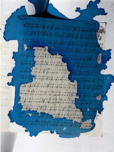 Photograph of code on paper with blue ink dye