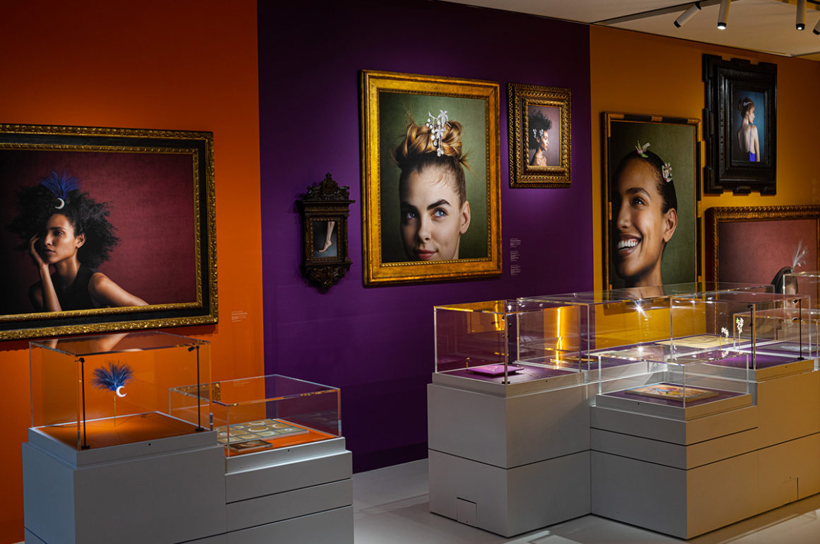 Installation shot of exhibition with display cases and photographs