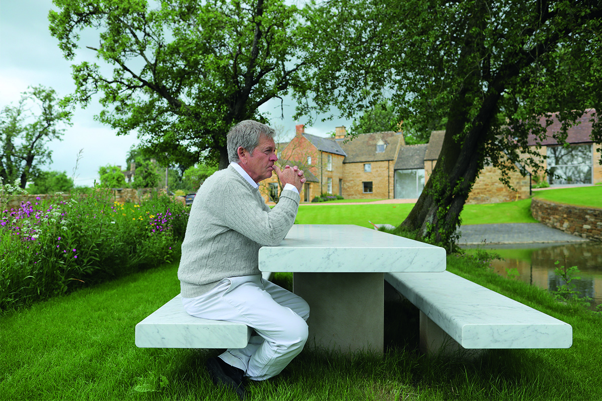 Man sitting on bench in garden