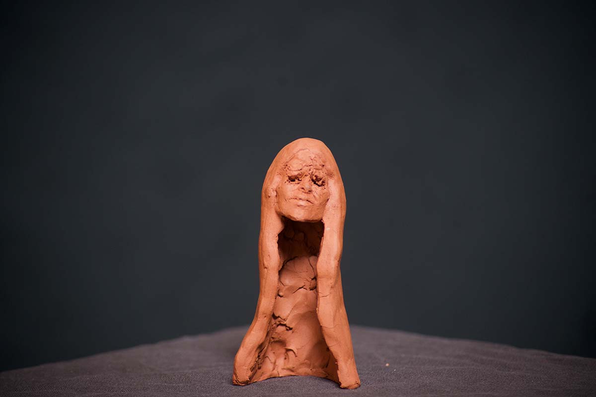 Sculpture of a woman's head formed in clay
