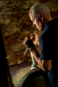 Wine maker sniffing a glass of red