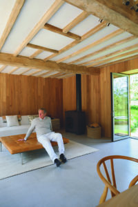 Man reclining against table in sitting room