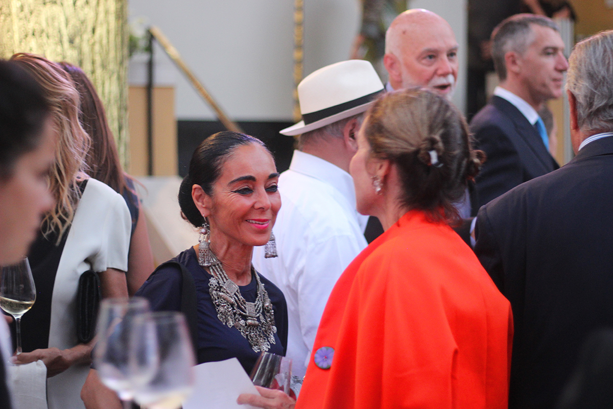 Two women speaking at a drinks party 