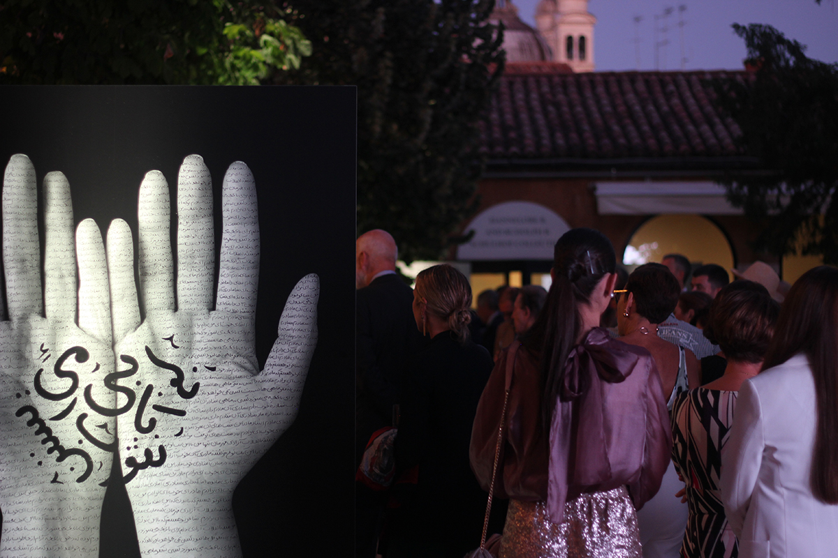 Courtyard party showing large monochrome artwork of hands