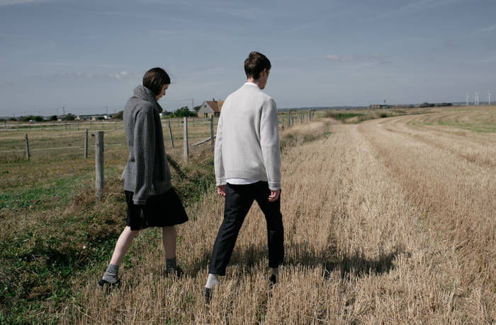Man and woman walking through stubble field