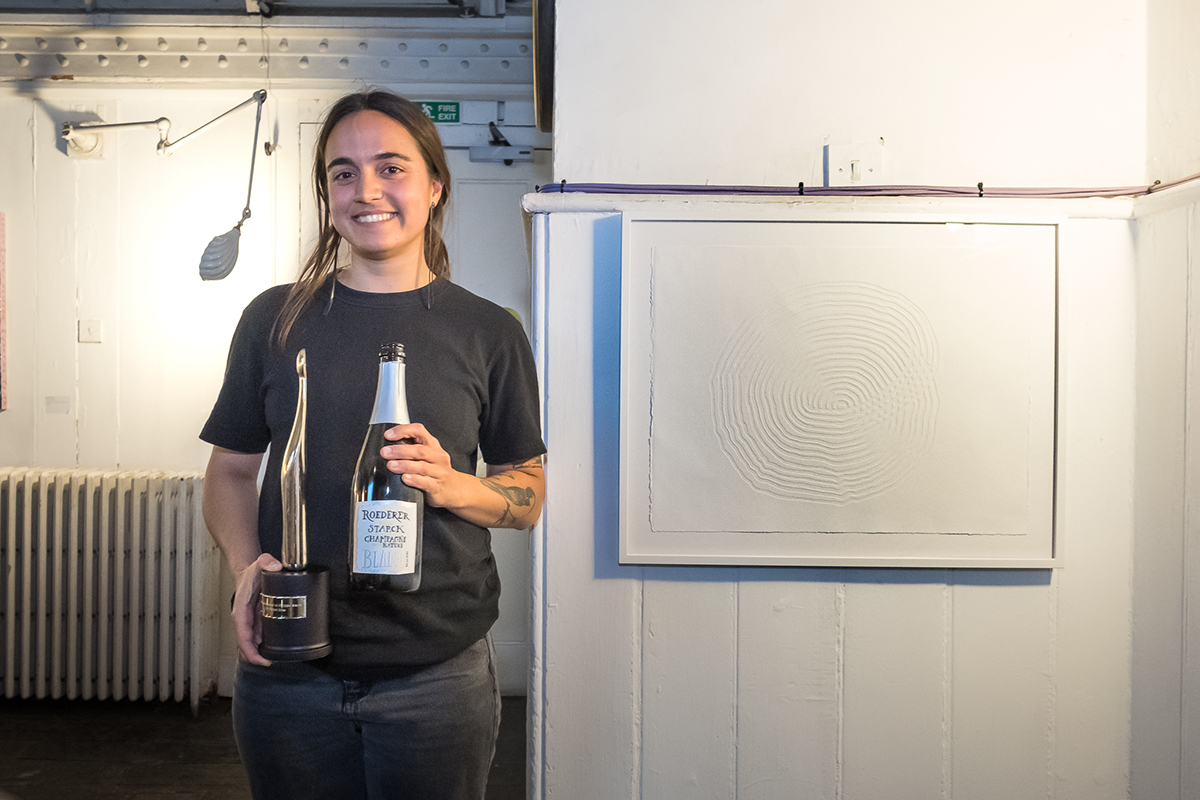 Girl holding trophy and bottle of champagne