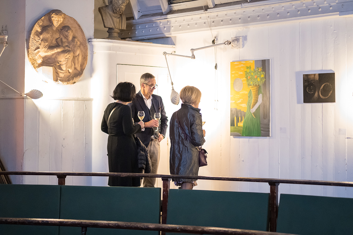 People admiring artworks in a gallery