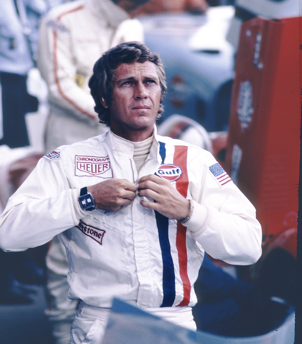 Actor Steve McQueen wearing racing gear