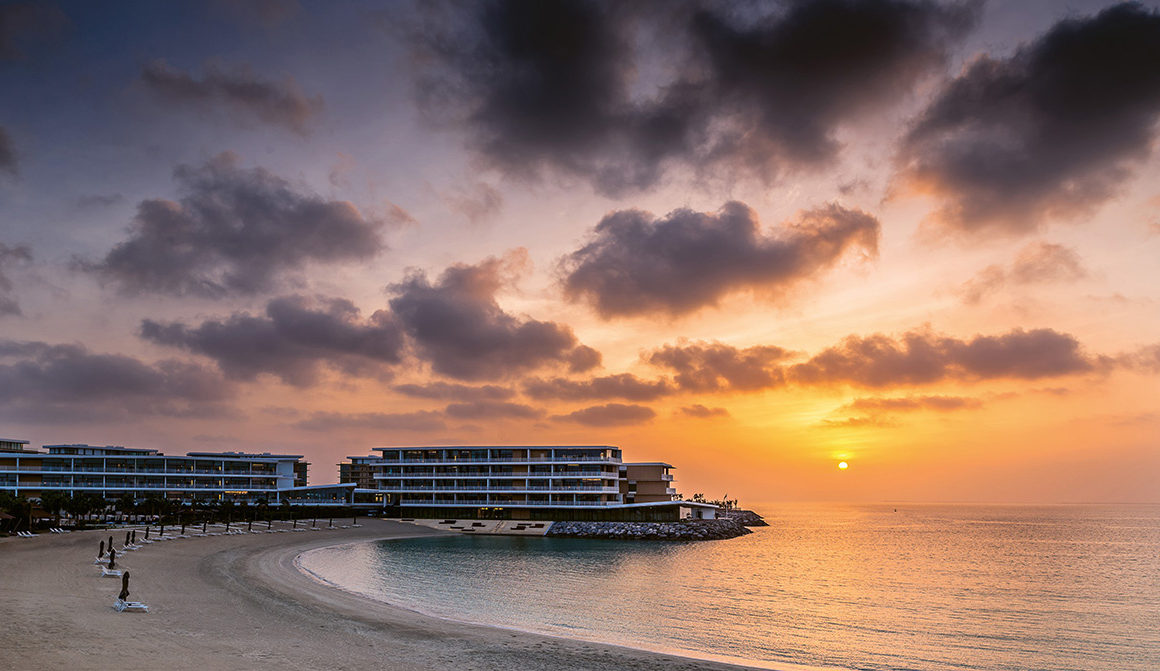 Luxury hotel on peninsula at sunset