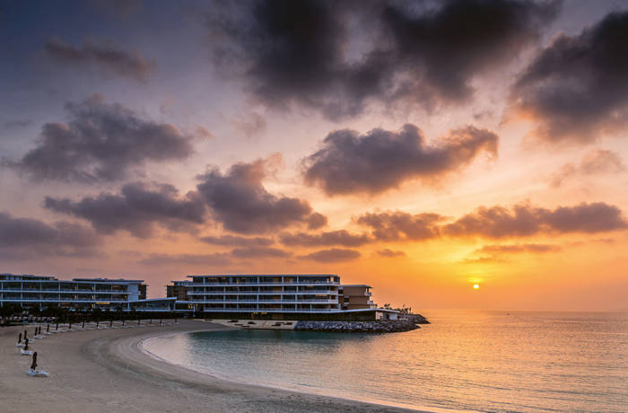 Luxury hotel on peninsula at sunset