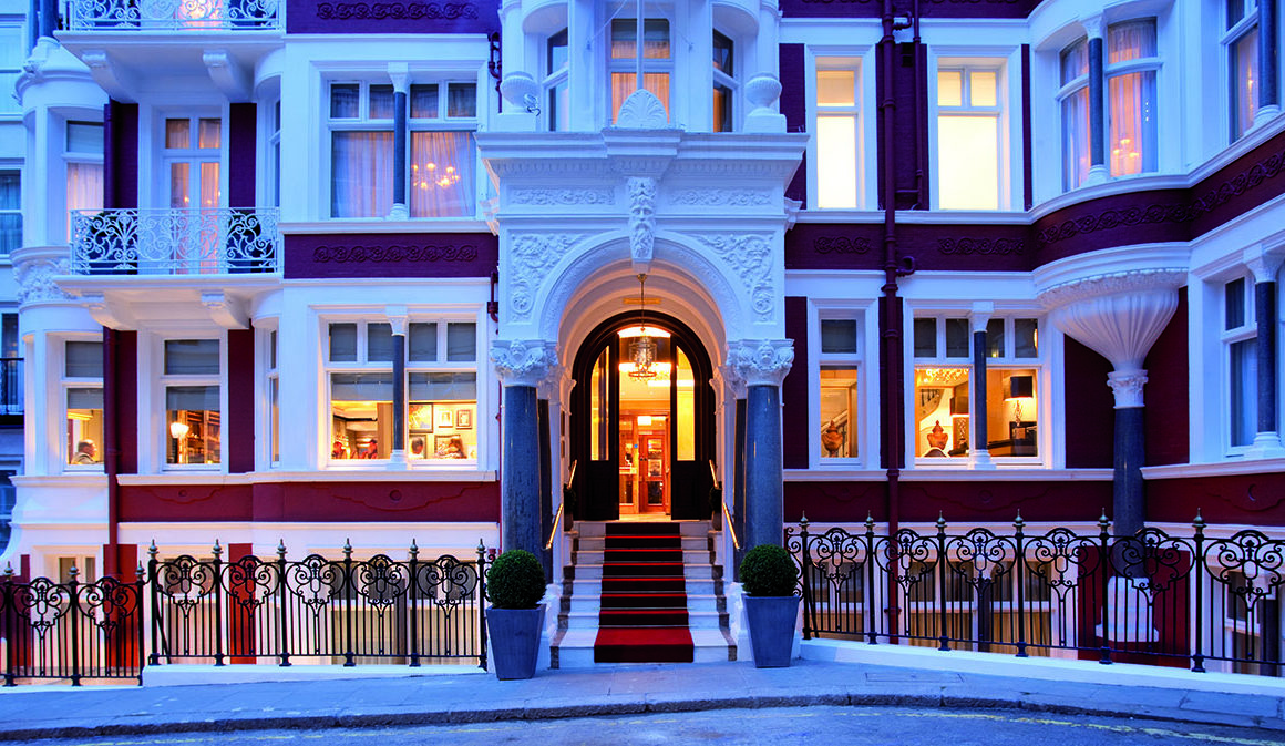 facade of Victorian townhouse with red brick and white windows