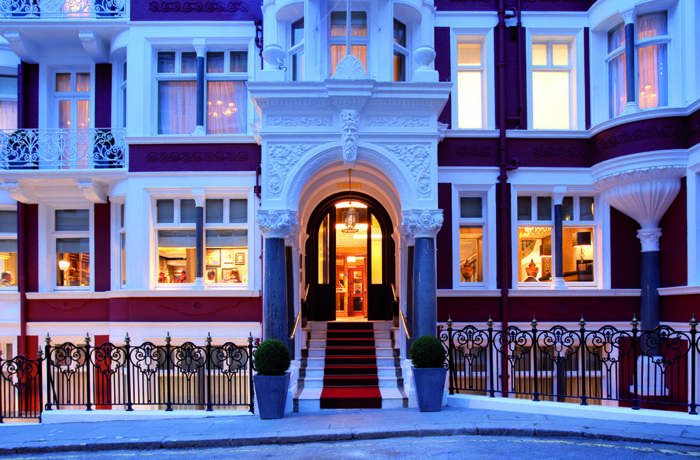 facade of Victorian townhouse with red brick and white windows