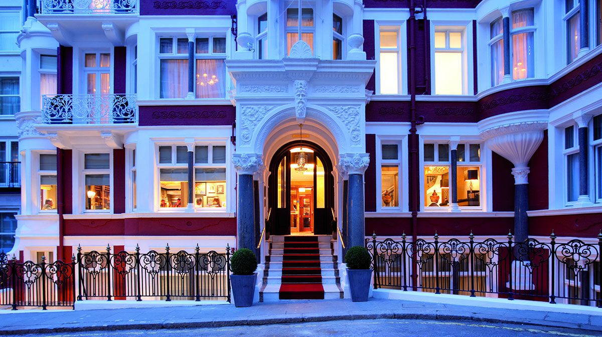 facade of Victorian townhouse with red brick and white windows