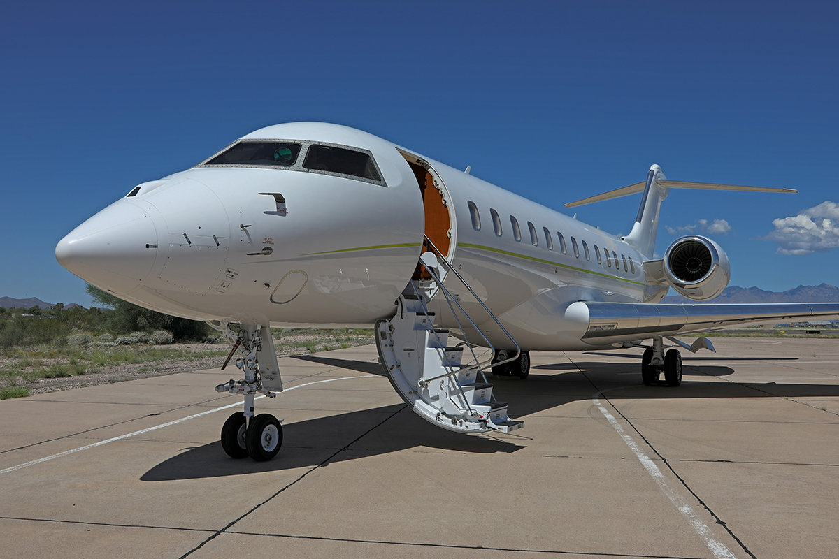 Private jet with ladder down on runway