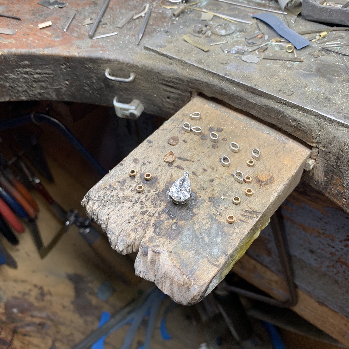 Precious stones shown on work bench inside a studio