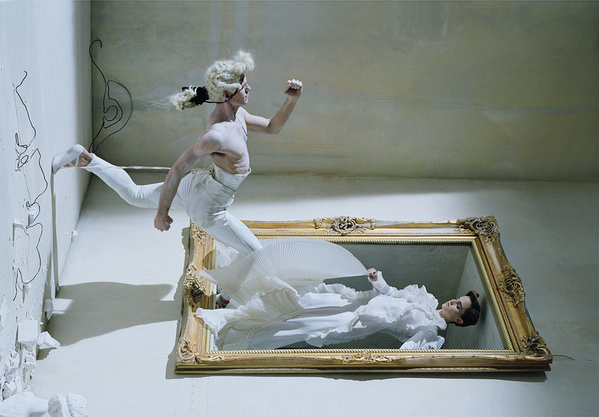 Surreal photograph of man jumping into a picture frame with woman inside