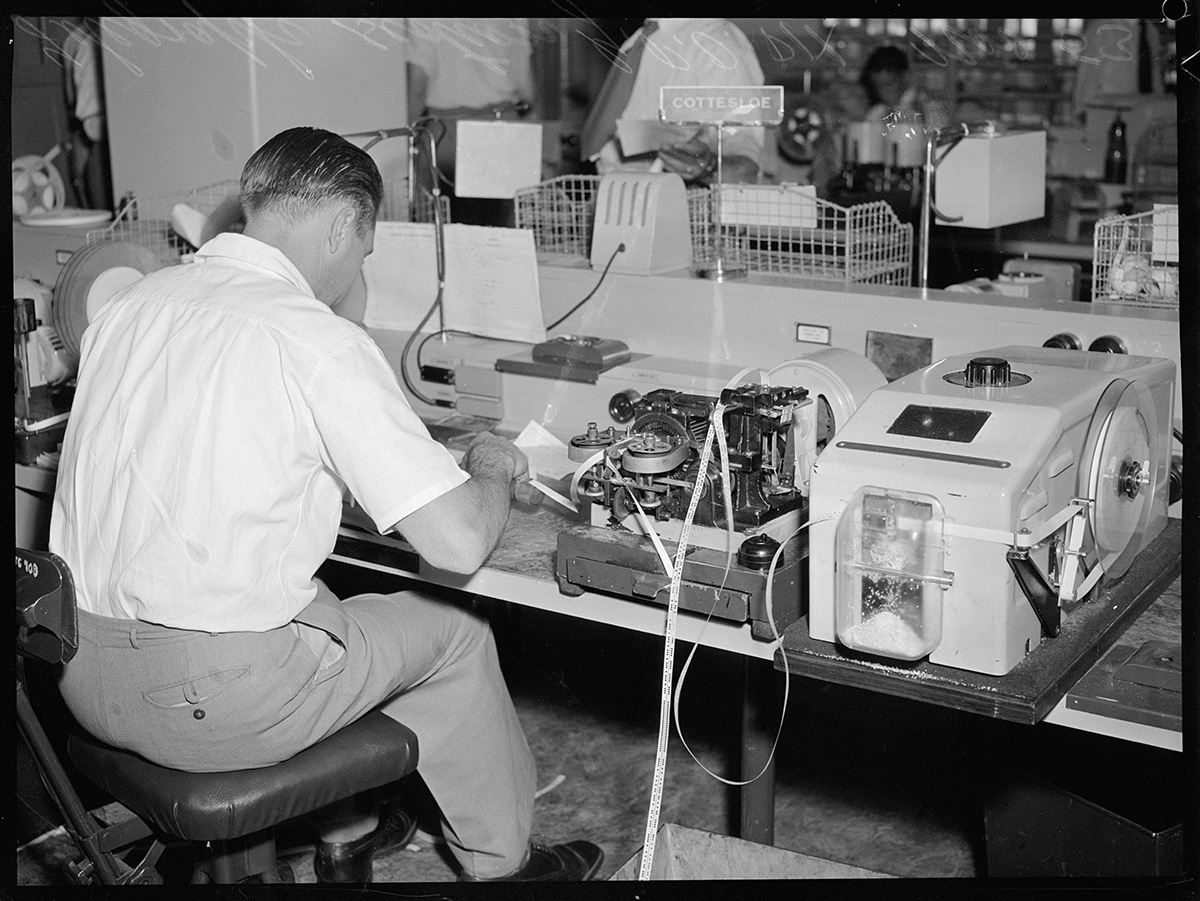 Vintage photograph of worker typing in office
