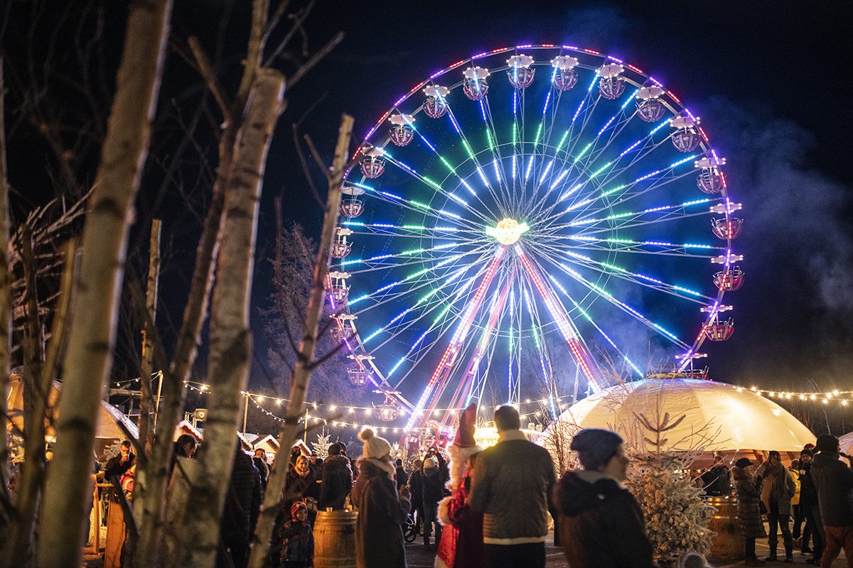 Glowing ferris wheel in Alpine setting