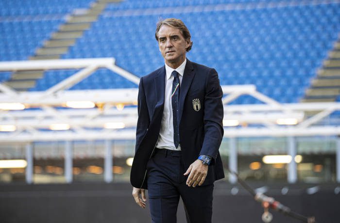 Man walking across stadium wearing watch