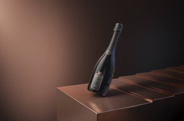 Prosecco bottle against brown background