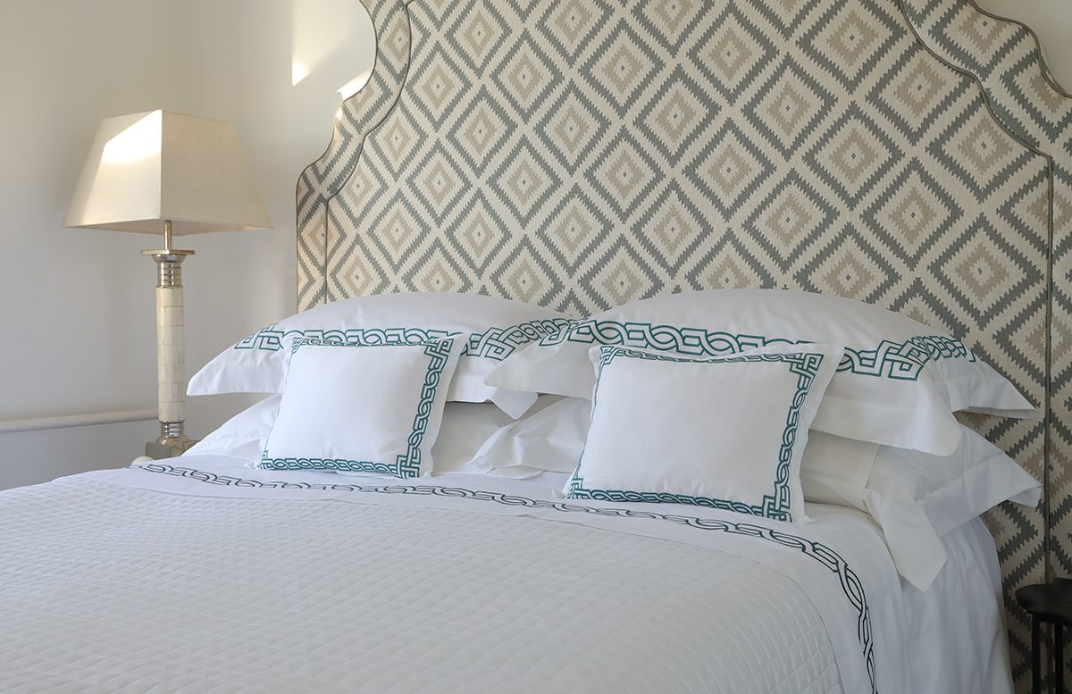Luxury bed with headboard and personalised linen