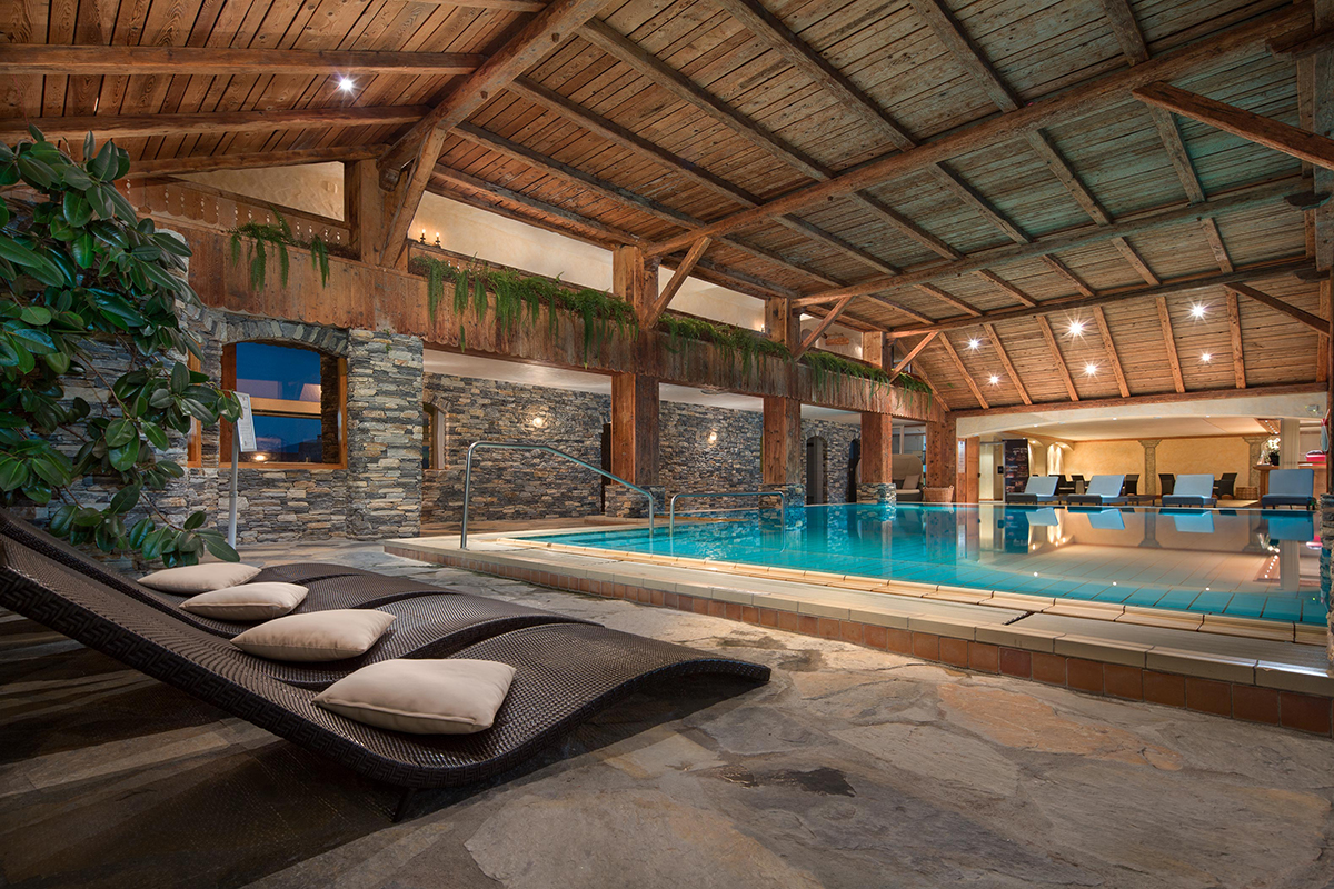 Luxurious indoor swimming pool with loungers