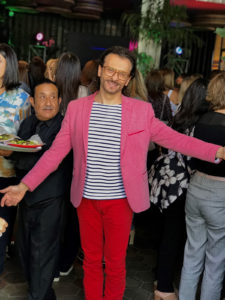 Man wearing pink suit jacket and red trousers