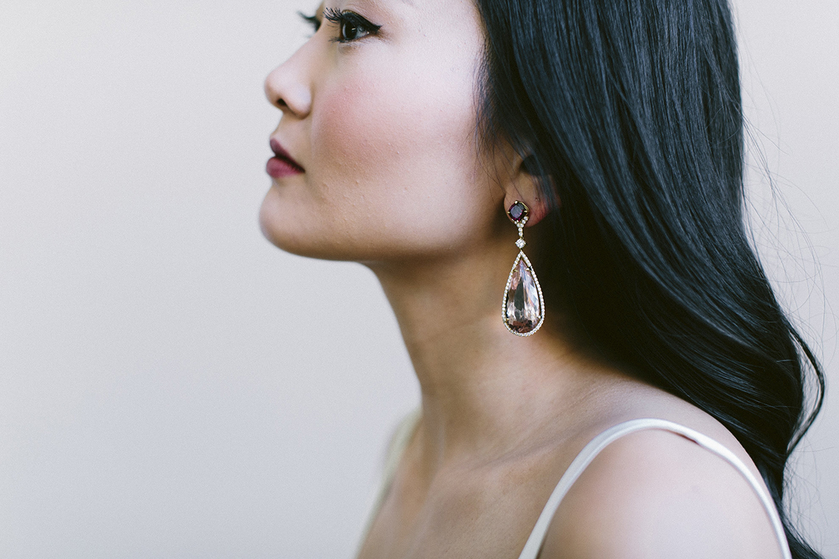 Model wearing drop earrings