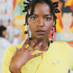 Portrait of young woman in yellow top