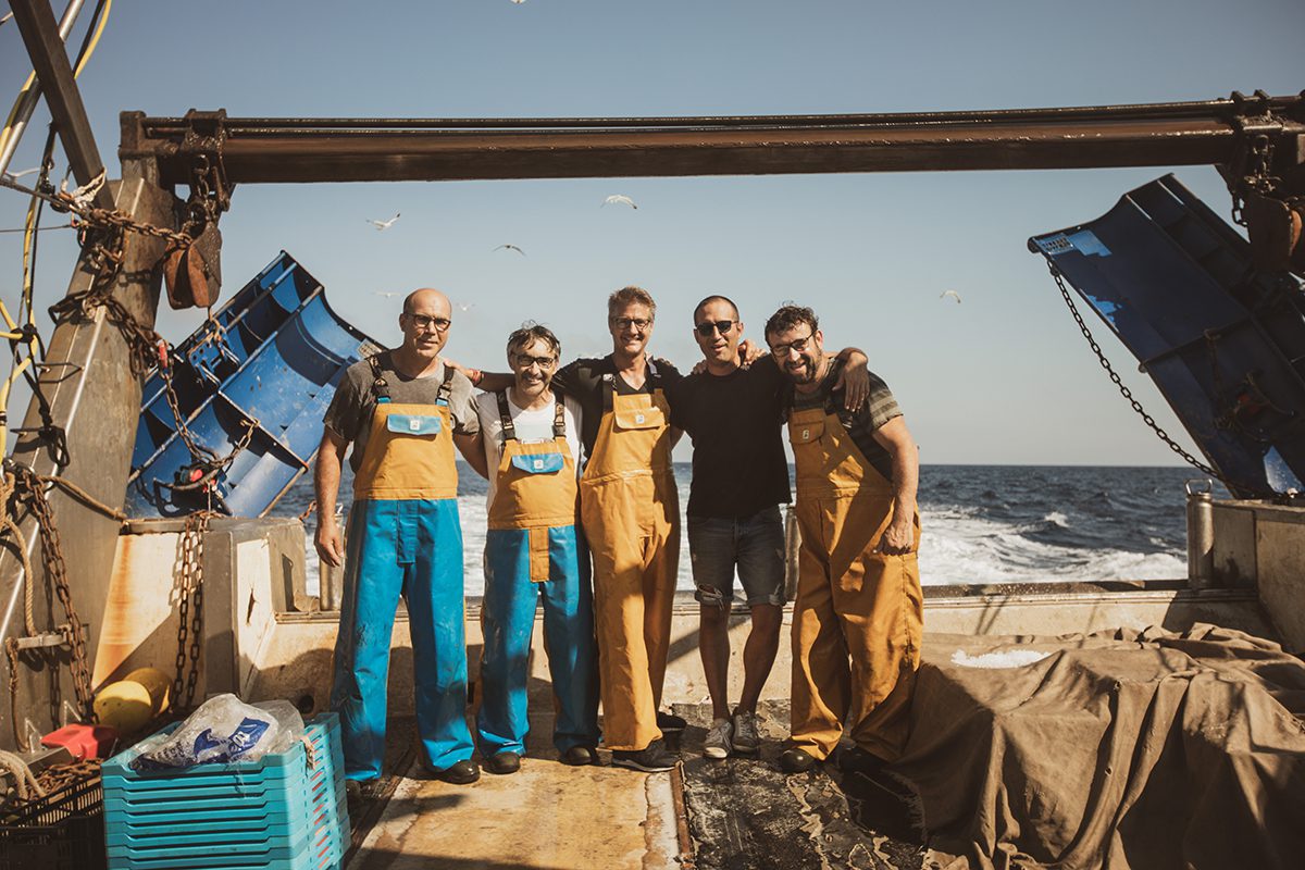 Fishermen standing on a boat deck