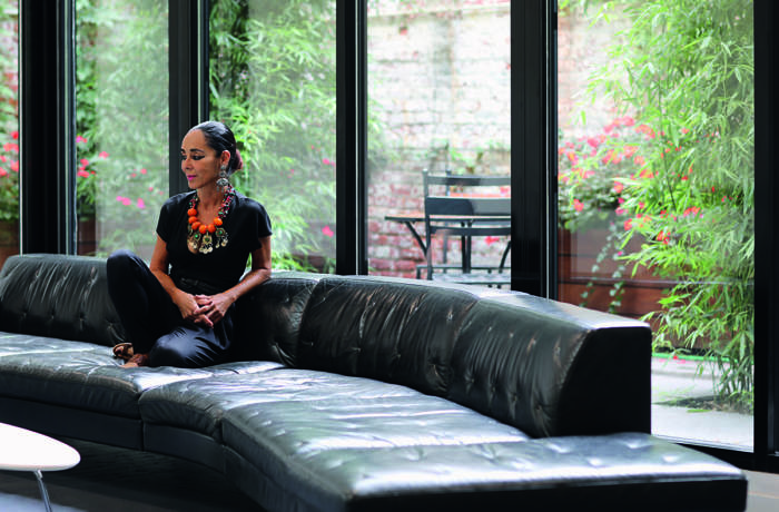 Woman sitting on leather sofa in a contemporary space