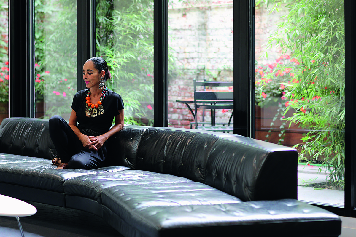 Woman sitting on leather sofa in a contemporary space