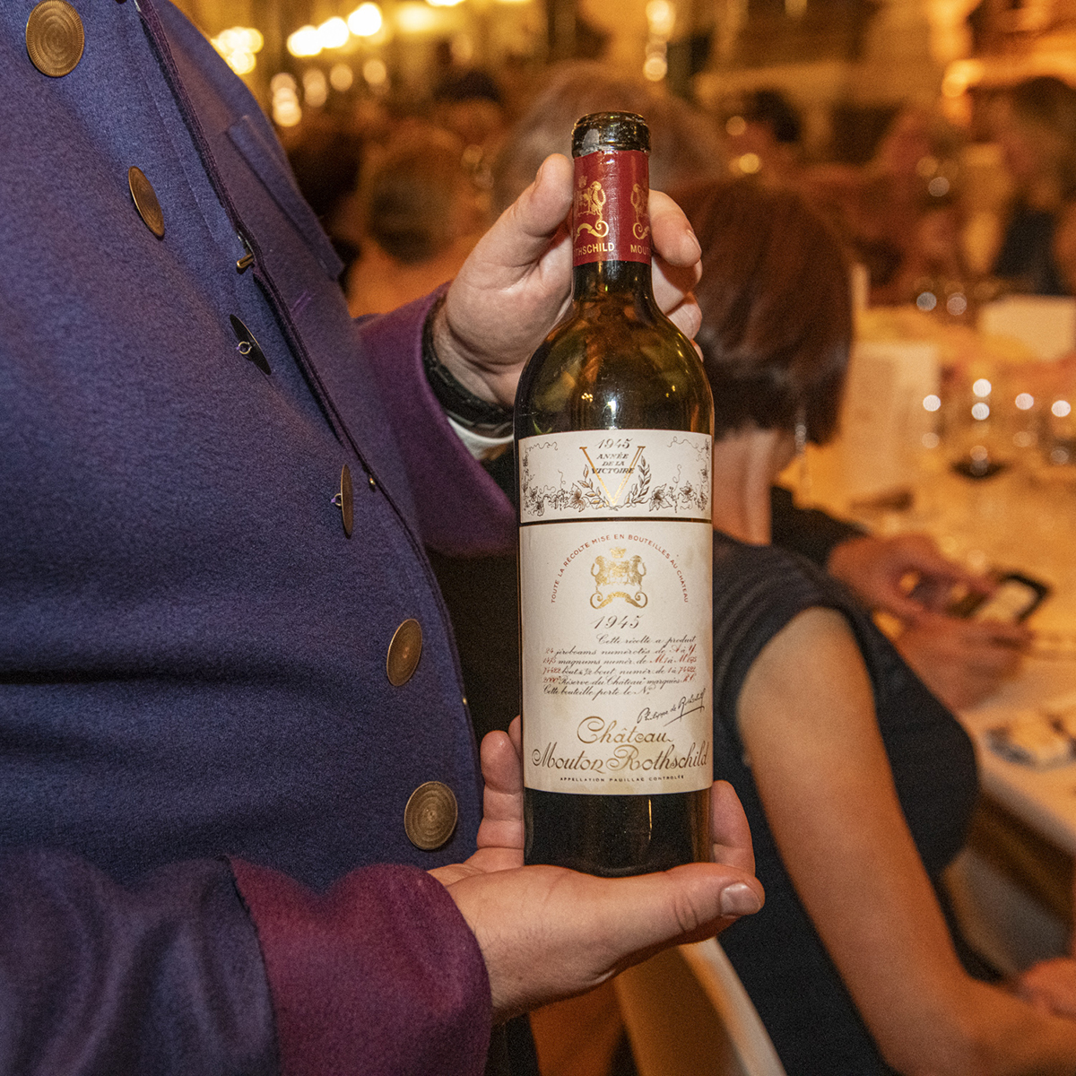 Bottle of vintage wine held by a waiter