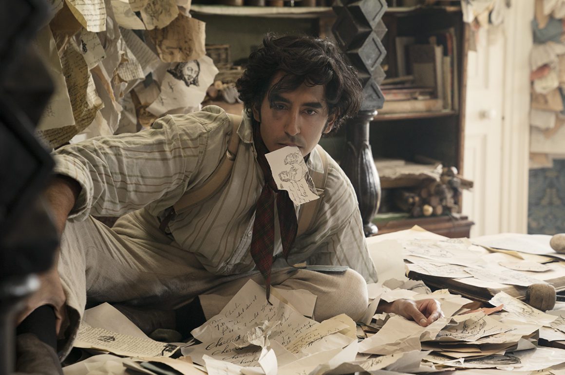 Man in office with paper in his mouth