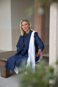 Woman sitting on steps of building