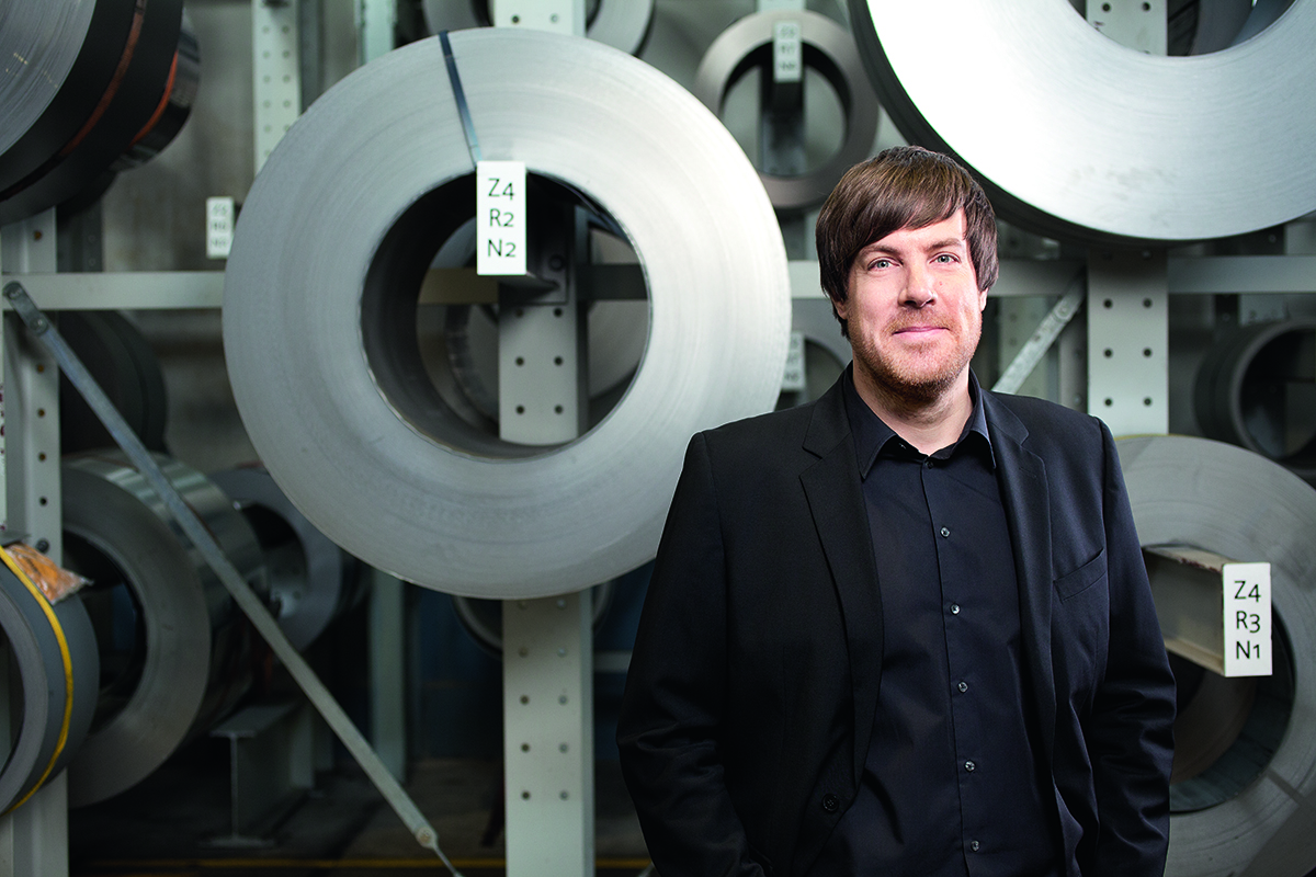 Man standing in front of factory background