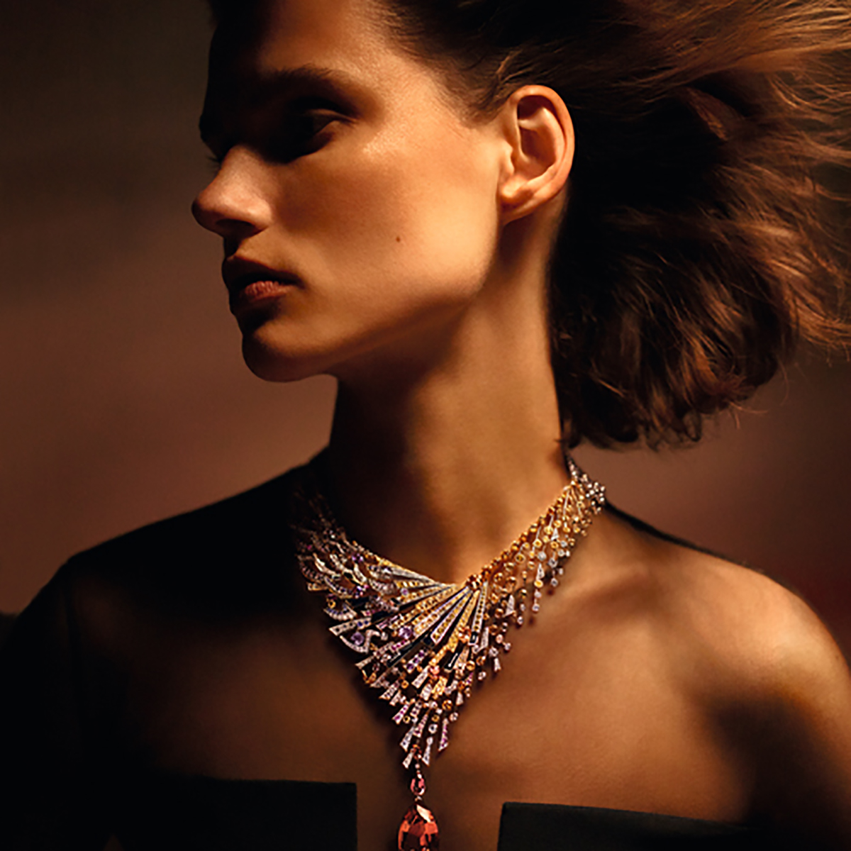 Model wearing large jewelled necklace