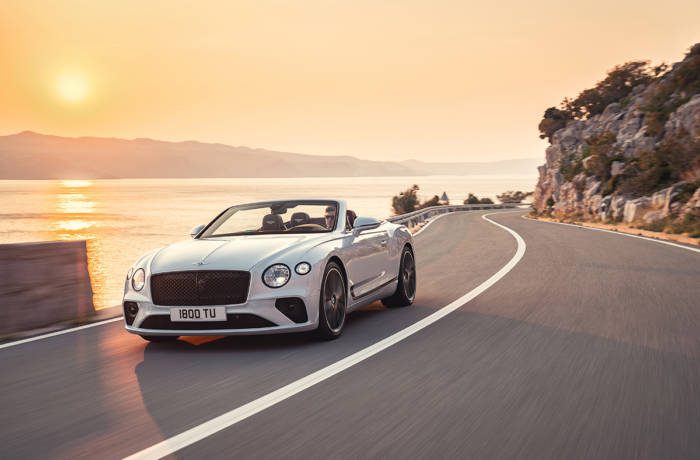 White convertible supercar on road