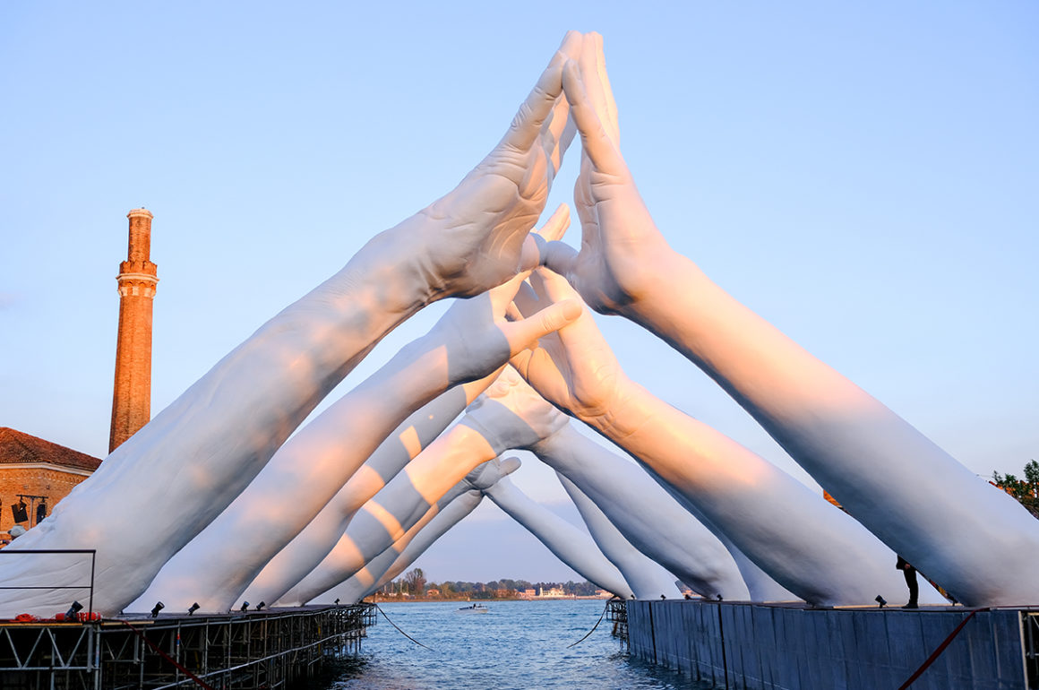 Sculpture of hands in a bridge