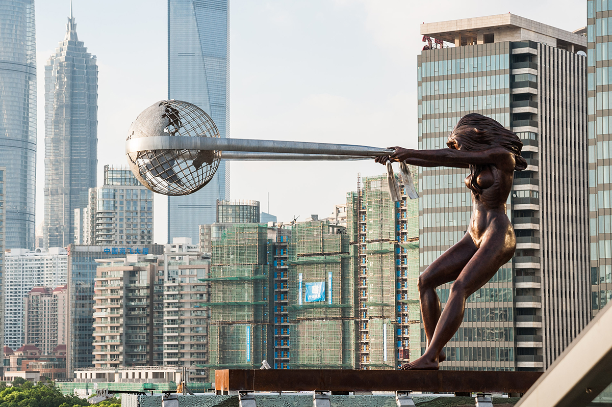 Sculpture of a woman pulling a globe